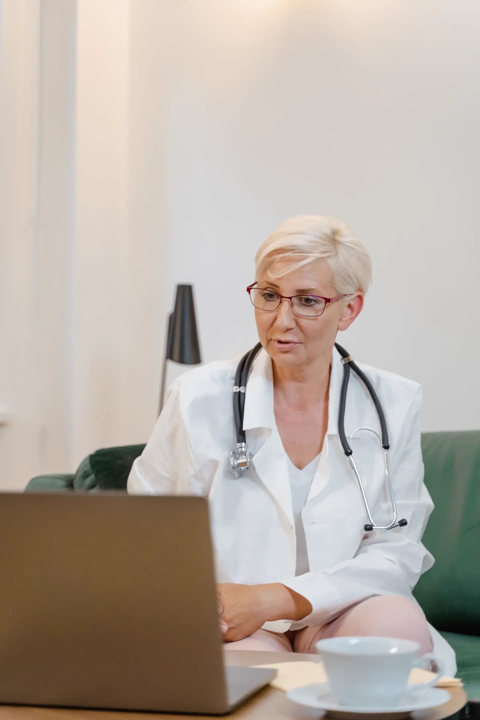 A physician using a laptop during a clinical work session